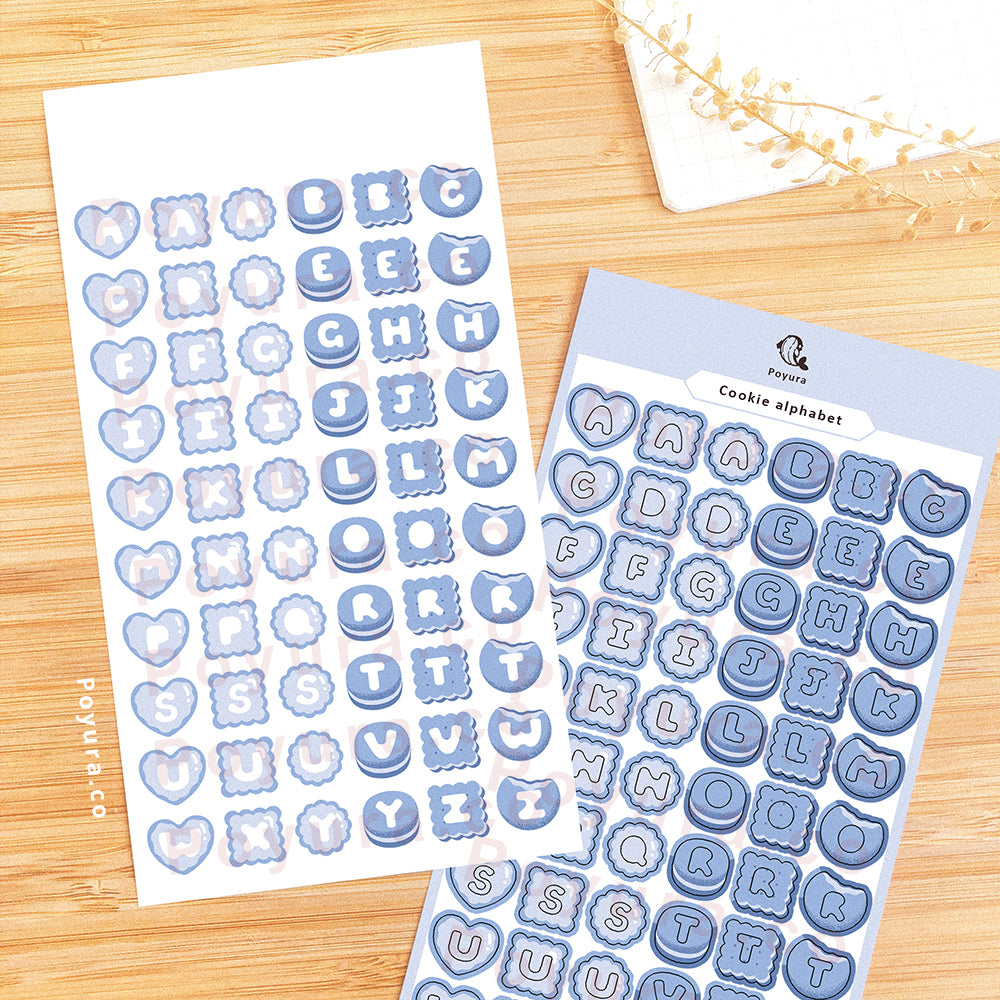 Sticker sheet of blue cookies with alphabet letter cutouts in the center.