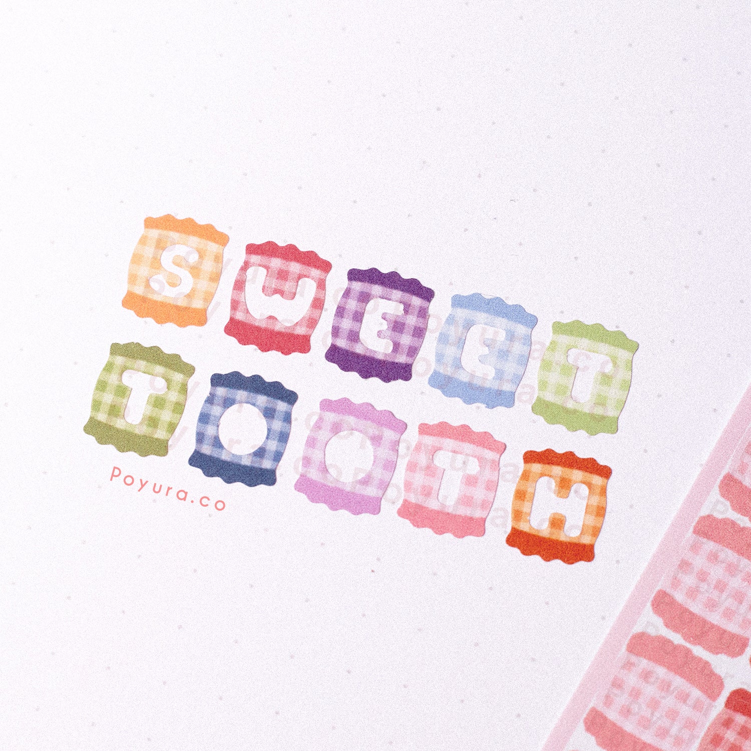 Stickers of cute sweets with a plaid pattern and letter cutouts on a journal spread