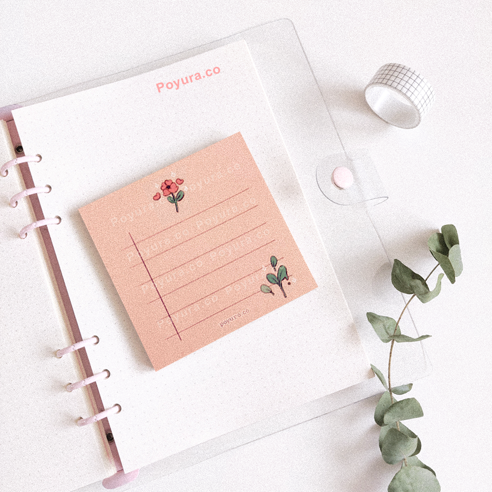 Pink memo notepad on a notebook