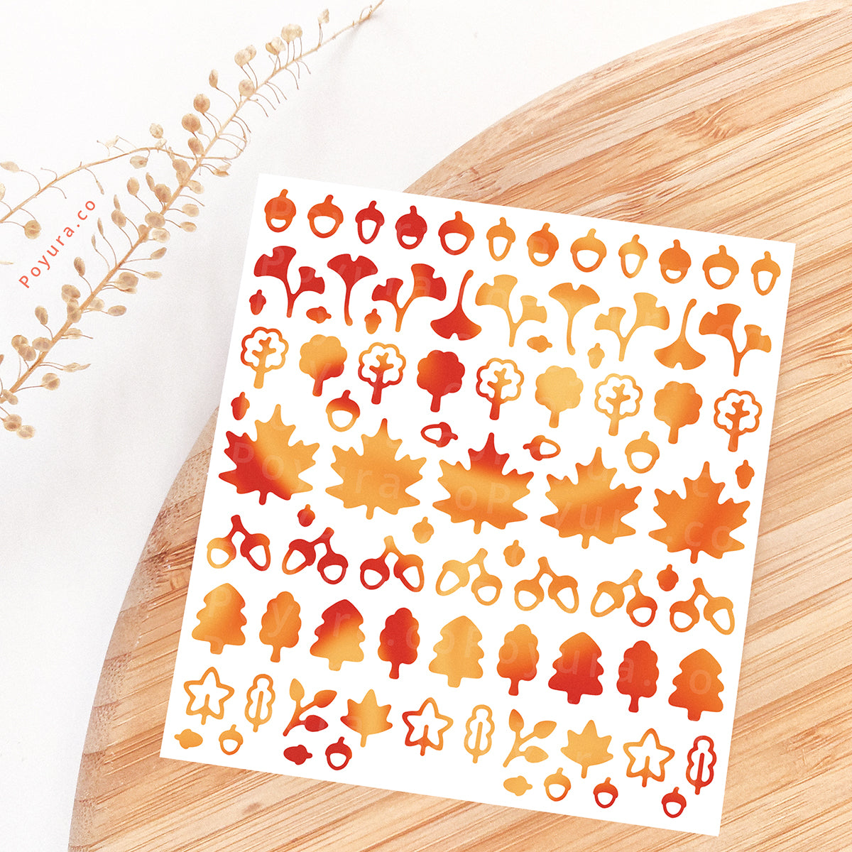 Borderless sticker with leaf and acorn cutouts in different orange and red tints