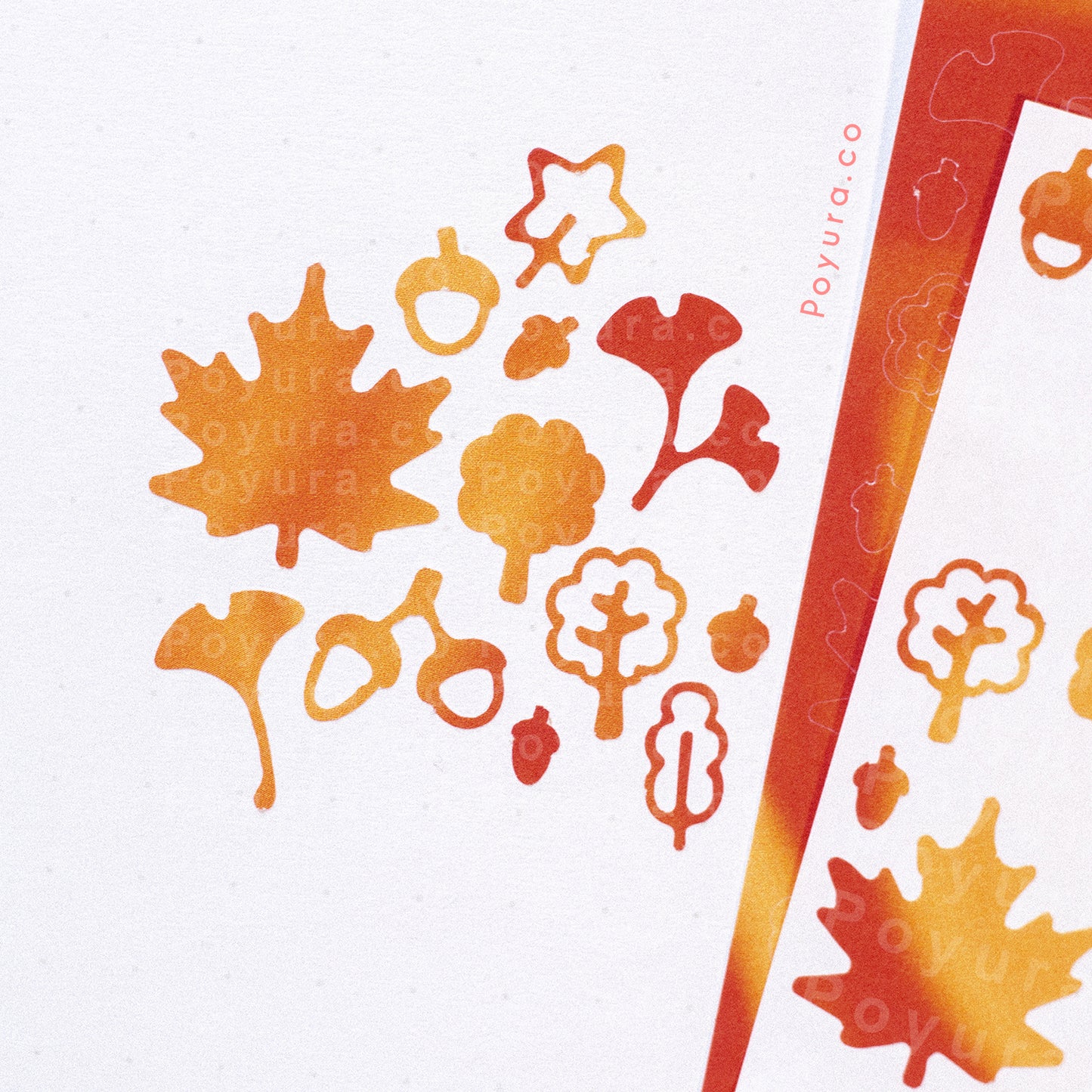Borderless sticker with leaf and acorn cutouts in different red and orange tints