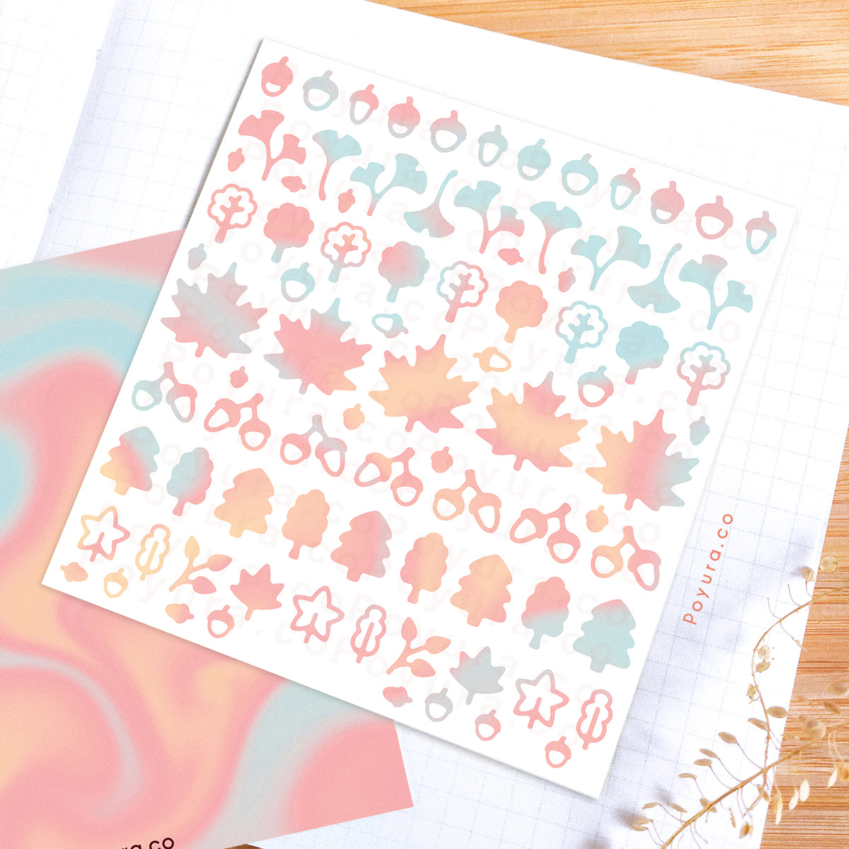 Borderless sticker with leaf and acorn cutouts in different blue, pink, and orange tints