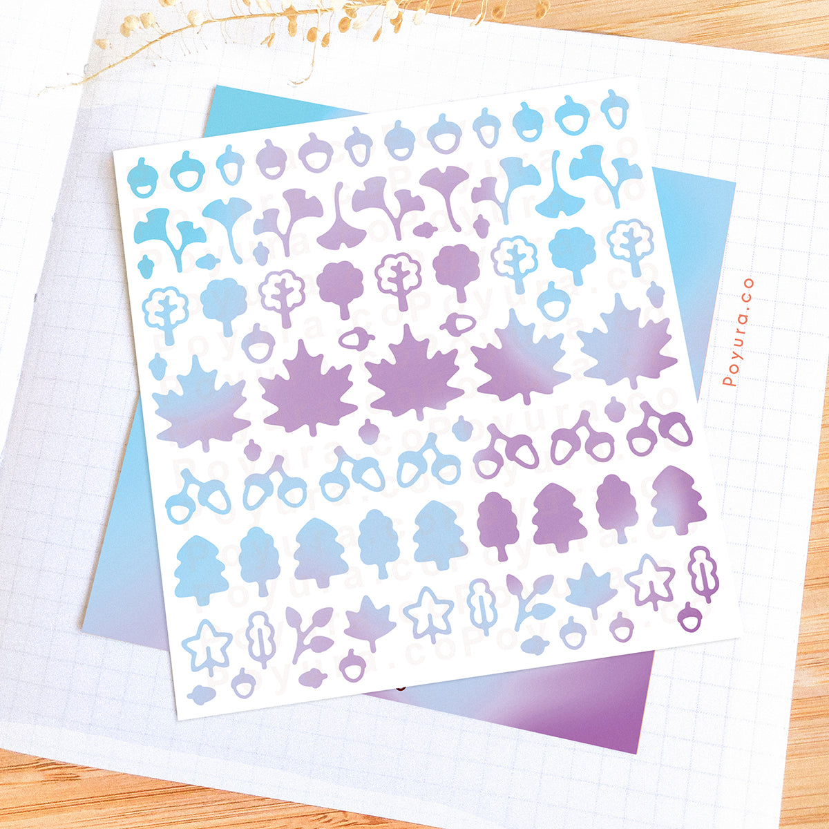 Borderless sticker with leaf and acorn cutouts in different blue and purple tints