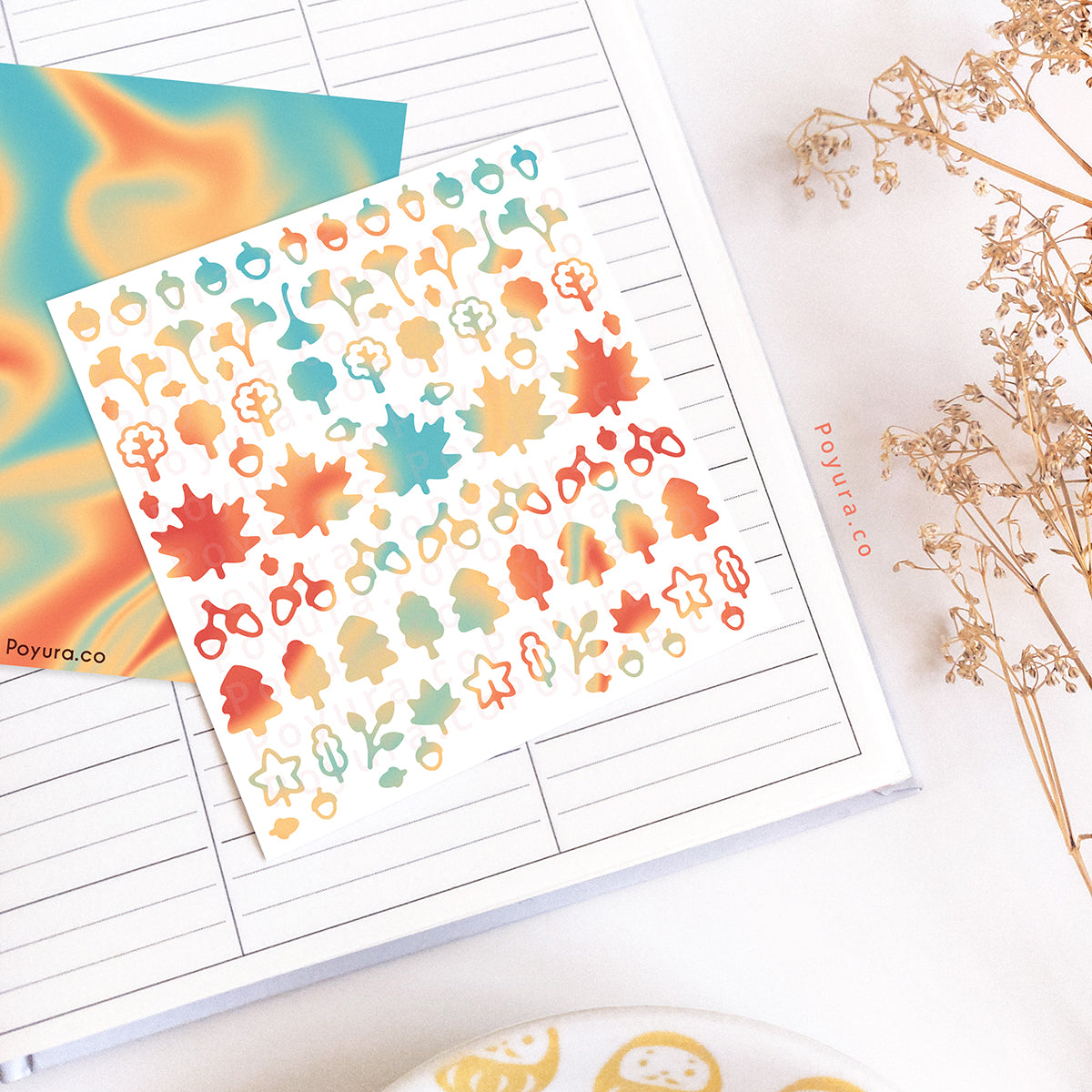 Borderless sticker with leaf and acorn cutouts in different blue, orange, and red tints