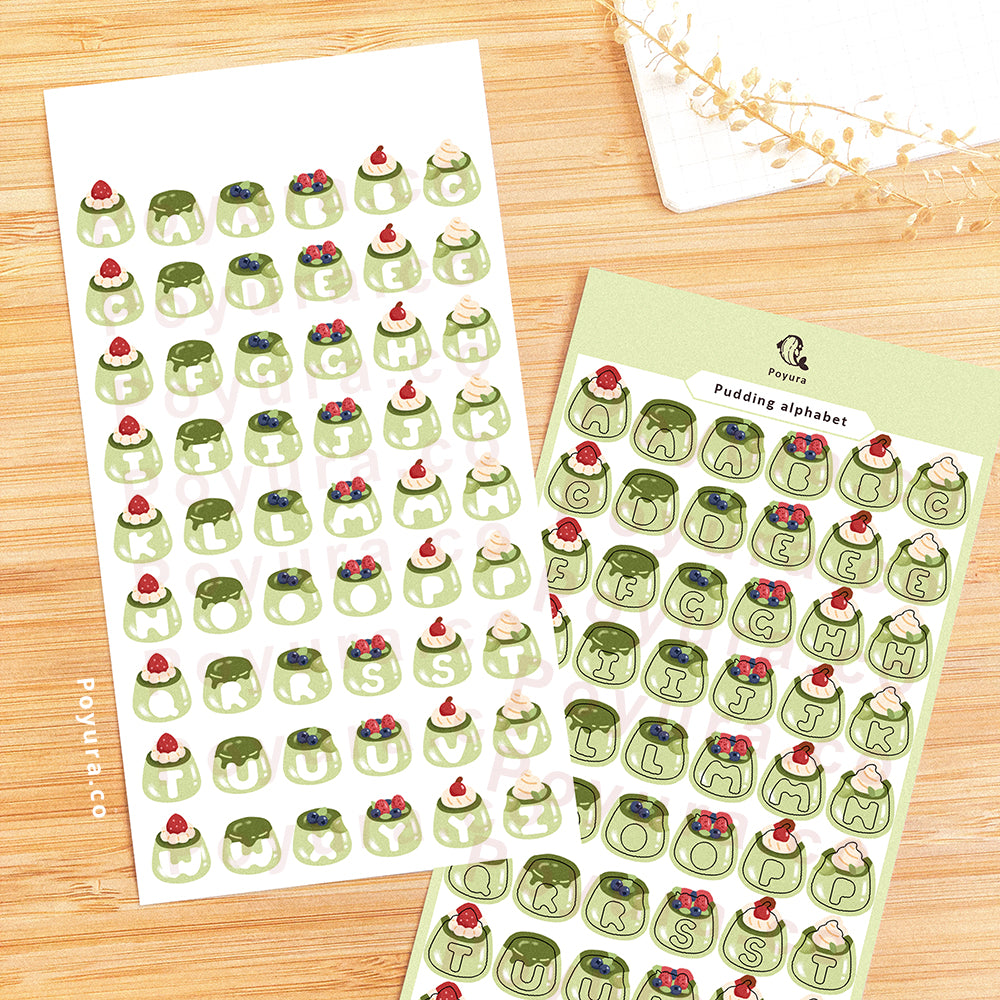 Sticker sheet of green puddings with alphabet letter cutout in the center.