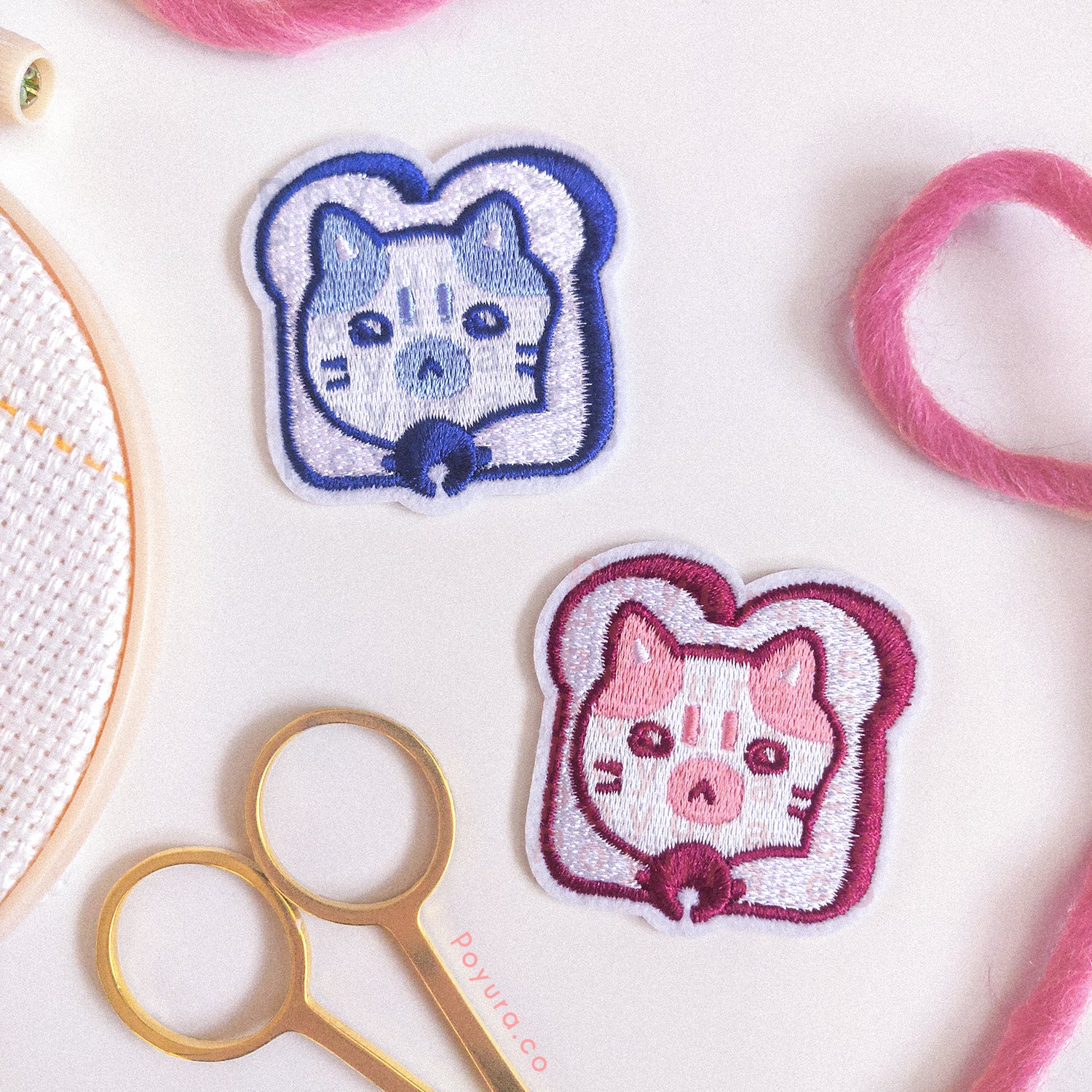 Set of one red and one blue embroidery patch of bread with a cat head poking out