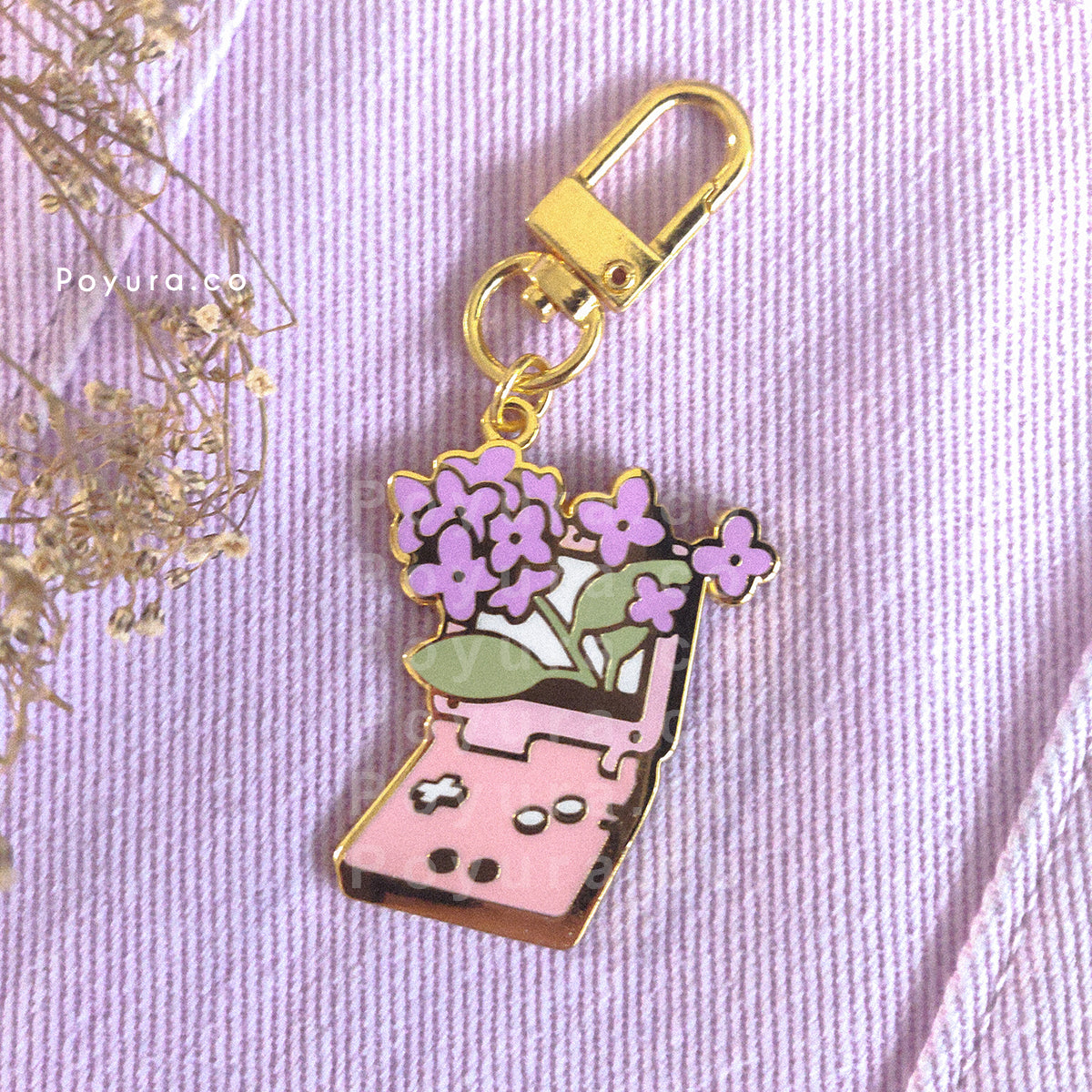 An enamel keychain of a cute game console with purple hydrangea