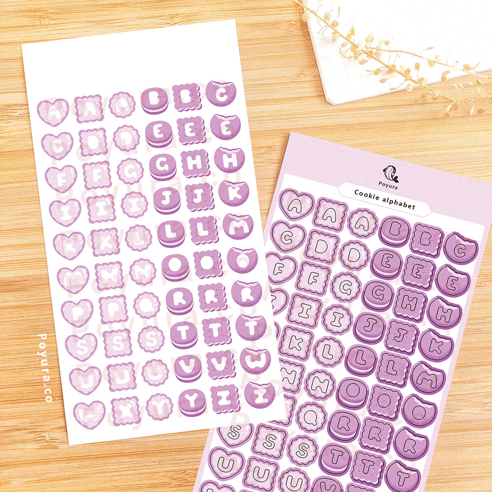 Sticker sheet of purple cookies with alphabet letter cutouts in the center.