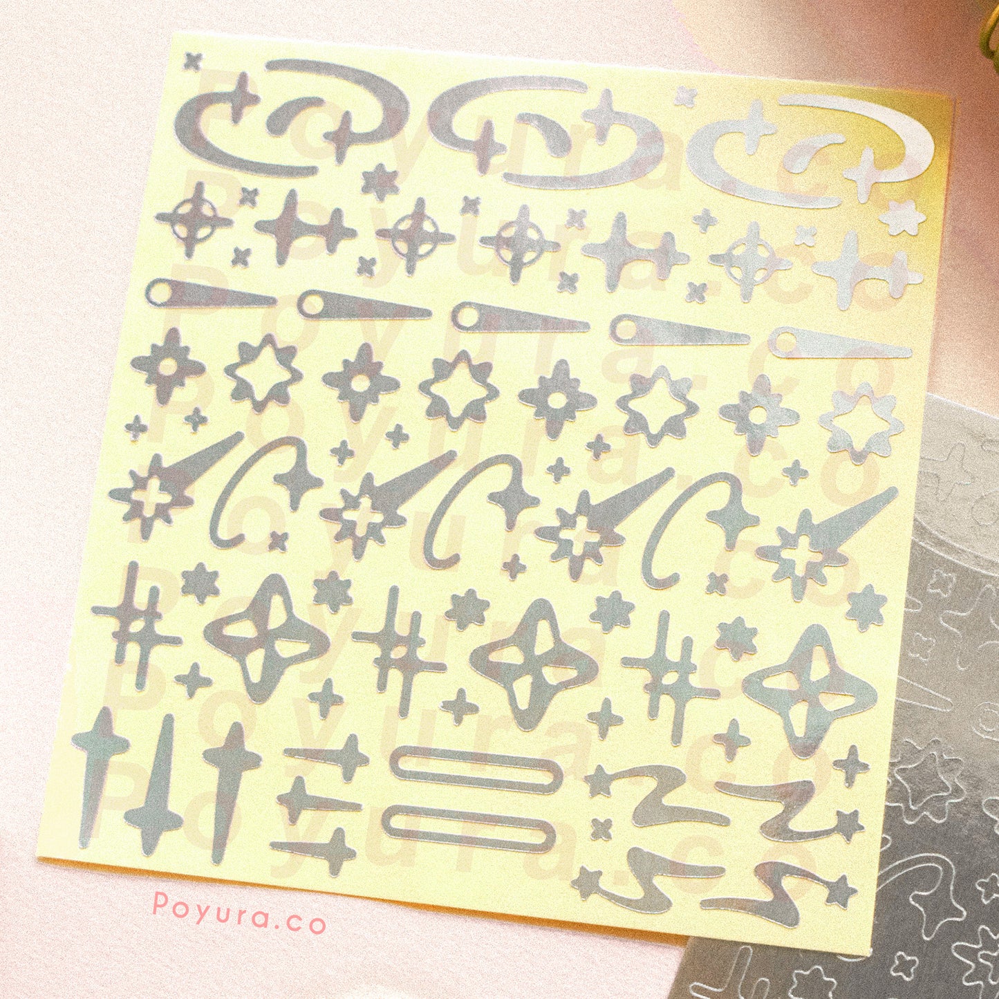 Borderless sticker with shooting star and sparkle cutouts in silver foil