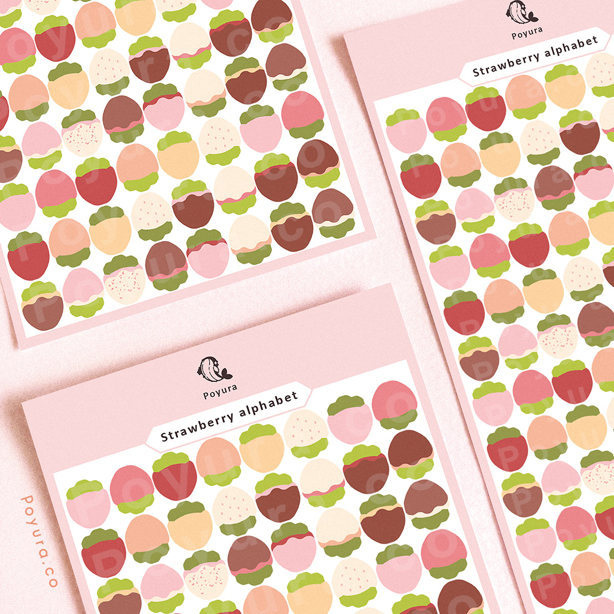 Sticker sheets of pink, red, and white strawberries, and some of them are covered in chocolate.
