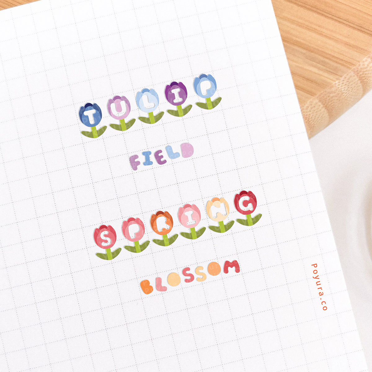 Journal spread decorated with tulips that have a letter cutout in the center. It forms the words 'tulip field' and 'spring blossom'.