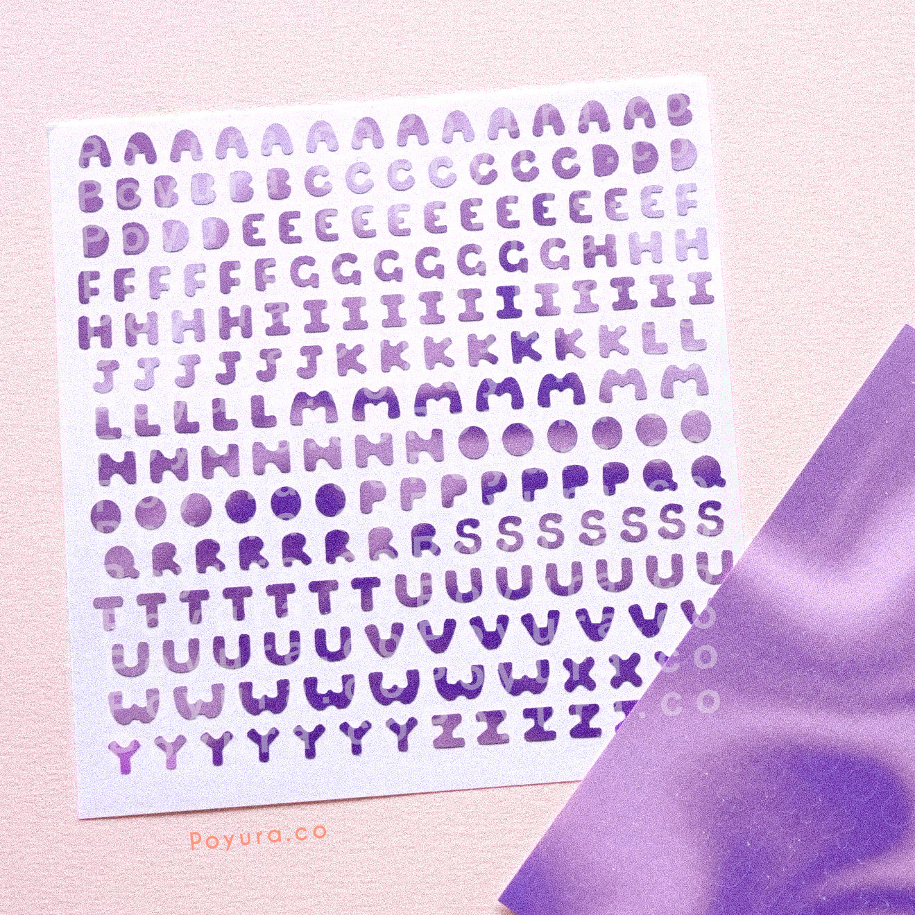 Borderless sticker with uppercase alphabet letter cutouts in different purple tints