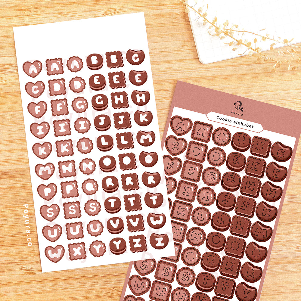 Sticker sheet of brown cookies with alphabet letter cutouts in the center. 