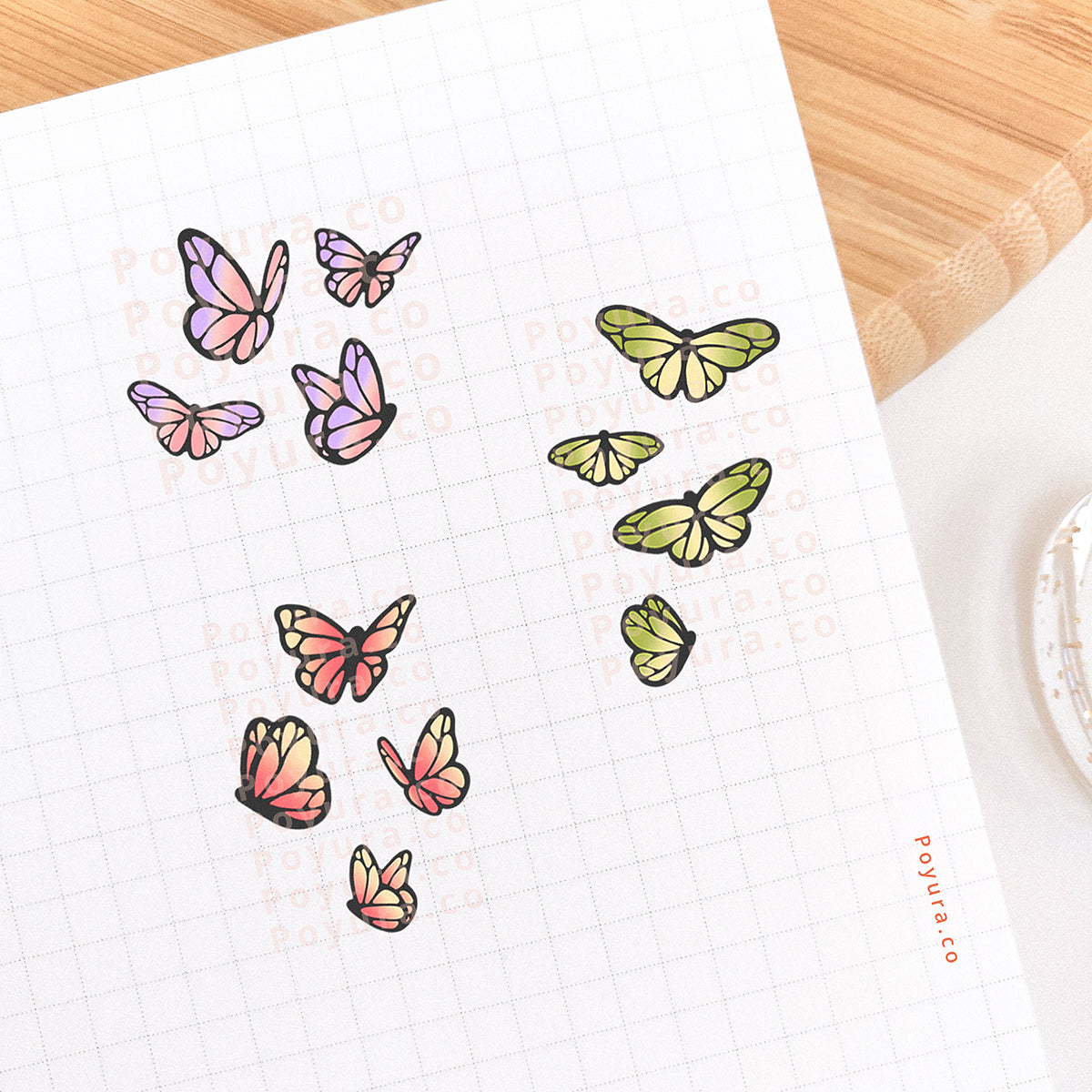 Journal spread decorated with stickers of butterflies and moths. There are pink, purple, and green butterflies.