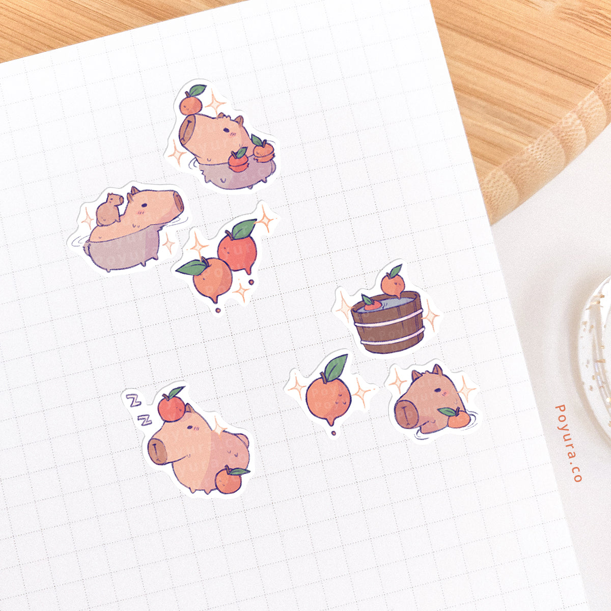 Journal spread decorated with stickers of capybara's taking a bath with yuzu's.