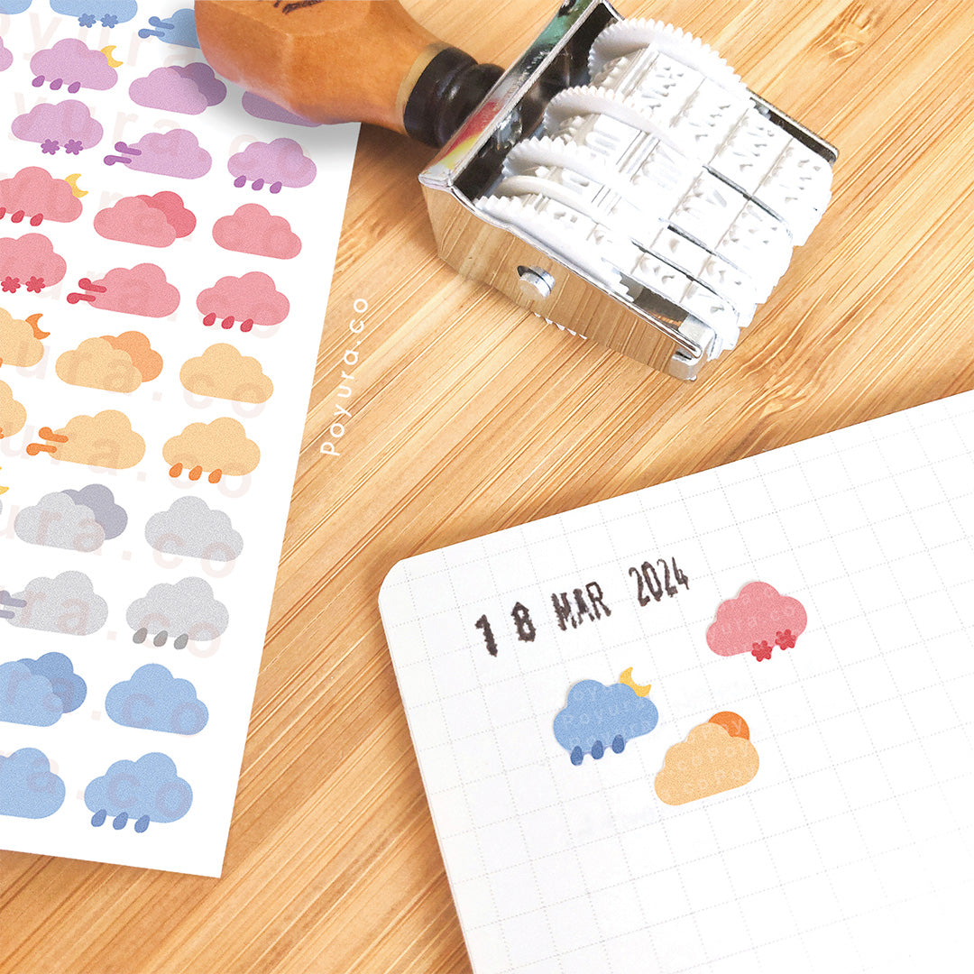 Sticker of cute weather clouds in different colors on a journal