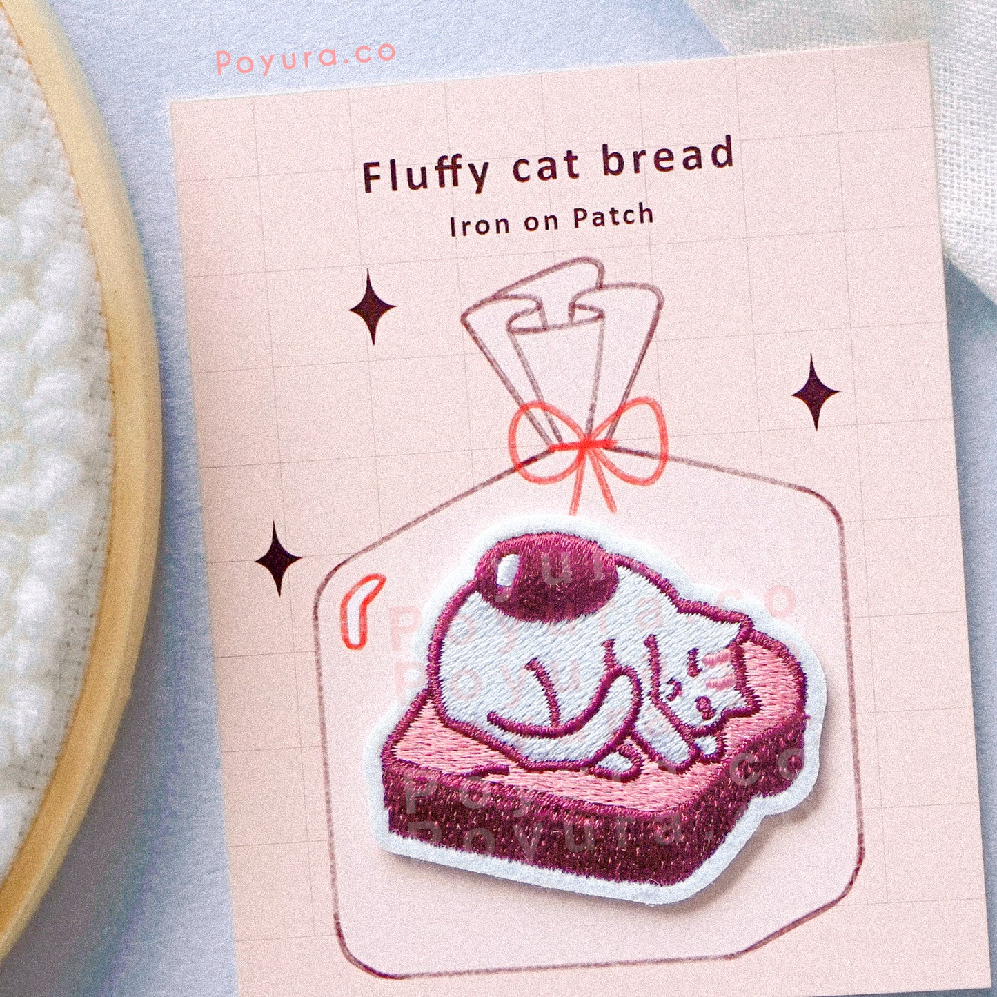 Embroidery patch of cat with an egg yolk laying on a fluffy bread