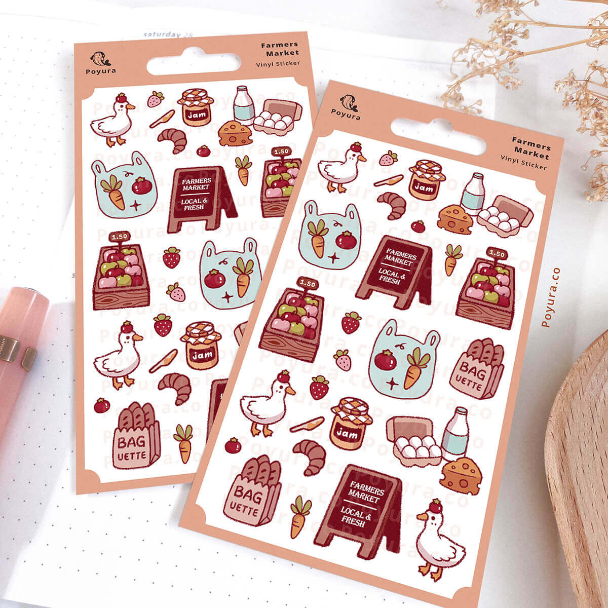 Two sheets of decorative stickers with farmers market-themed designs on a white notebook.