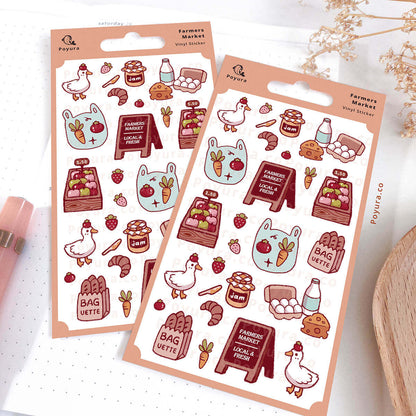 Two sheets of decorative stickers with farmers market-themed designs on a white notebook.