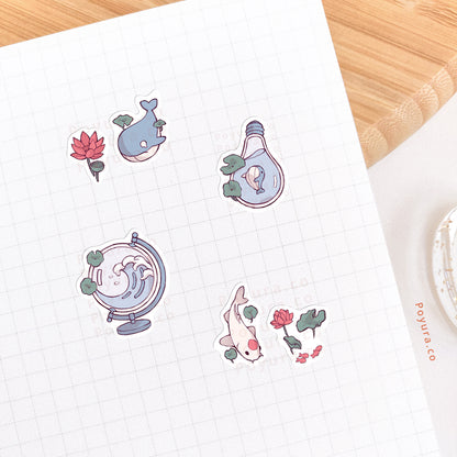 Journal spread that's decorated with stickers of whales, koi fishes, and red lotus flowers.