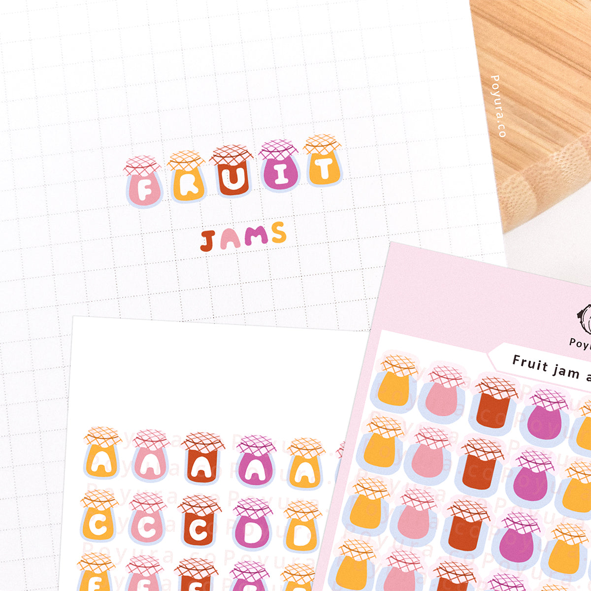 Stickers of cute fruit jam with alphabet letter cutouts on a journal