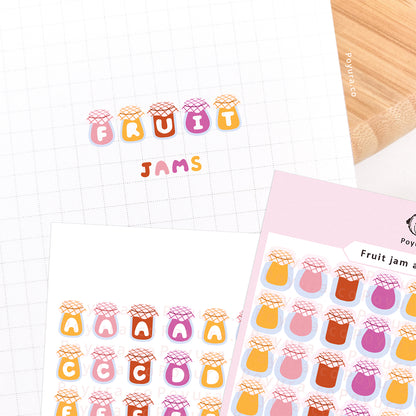 Stickers of cute fruit jam with alphabet letter cutouts on a journal