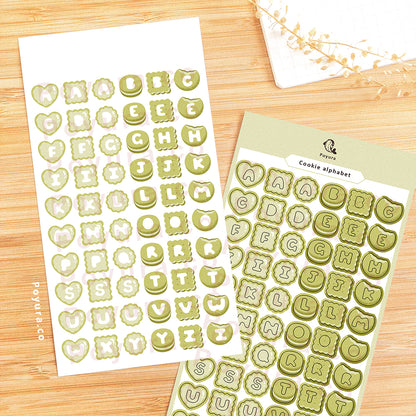 Sticker sheet of green cookies with alphabet letter cutouts in the center.