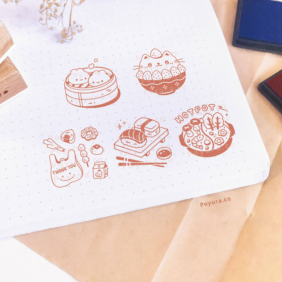 A notebook is stamped with Asian food-themed decoration. A brown ink pad was used for the stamps.