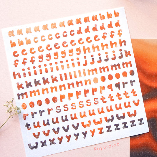Borderless sticker with lowercase alphabet letter cutouts in different brown tints