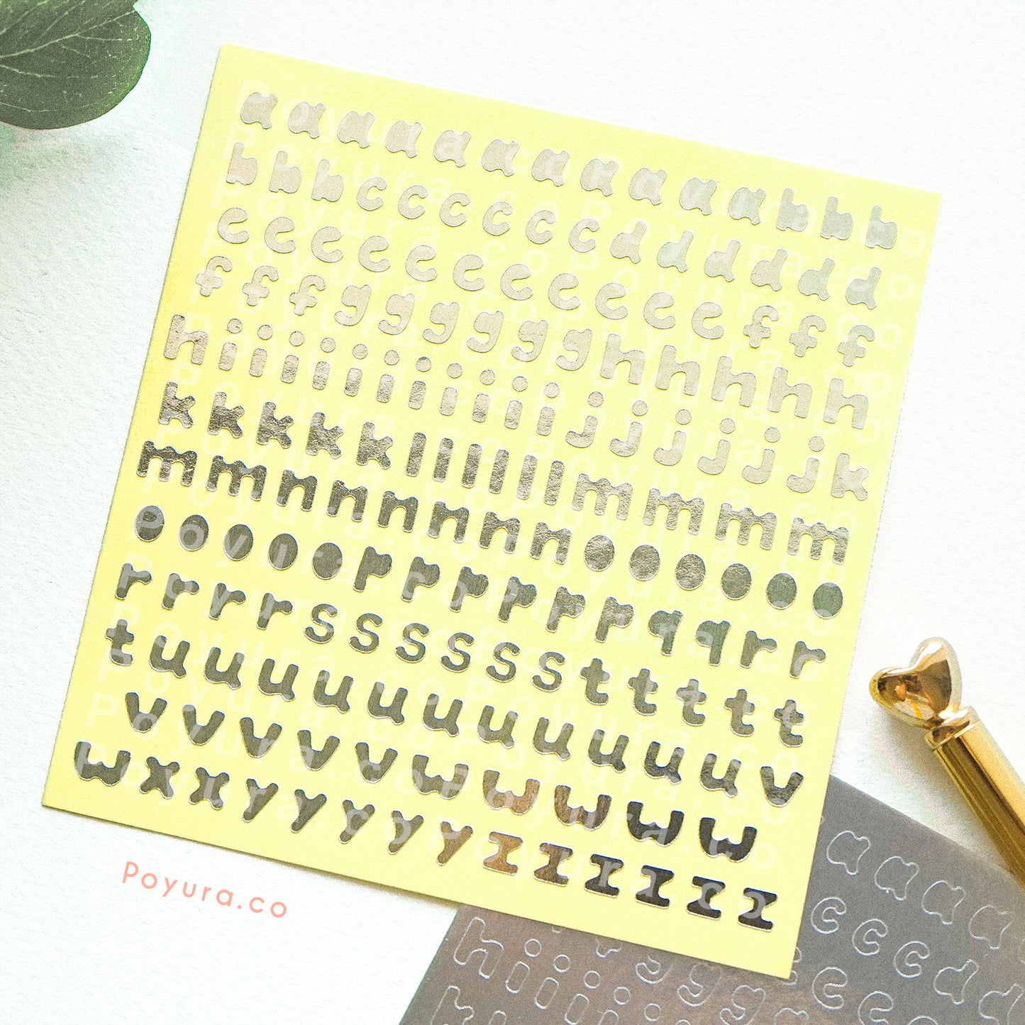 Borderless sticker with lowercase alphabet letter cutouts in silver foil