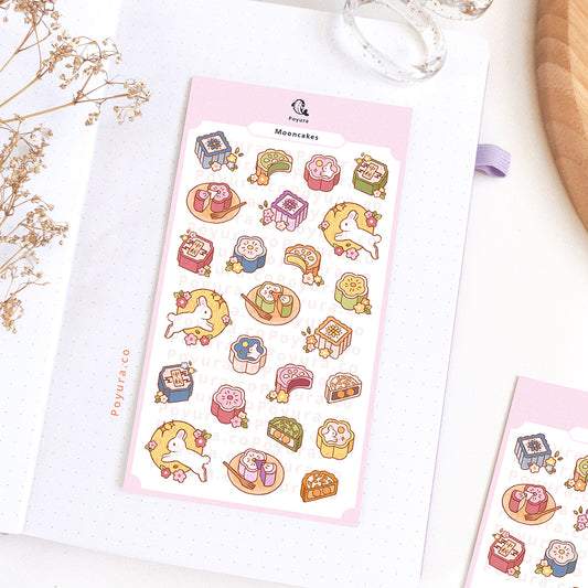 Sticker sheet of colorful mooncakes. They are decorated with flowers and white bunnies.