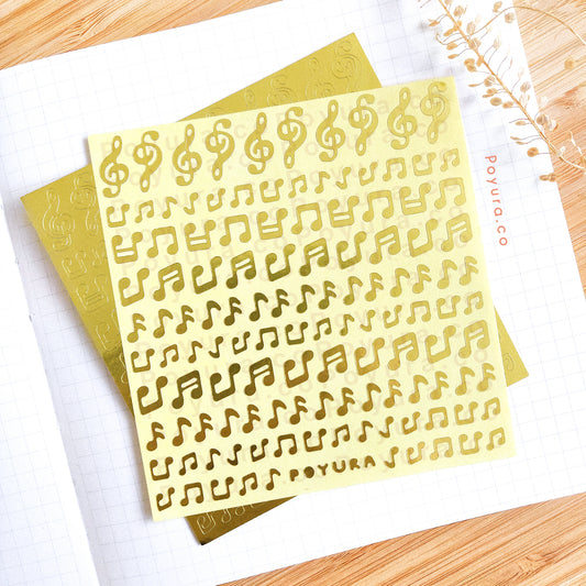 Borderless sticker with music note cutouts in gold foil