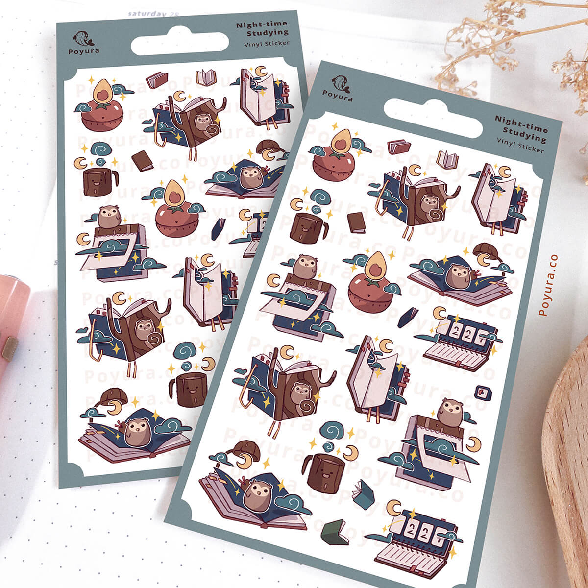 Two sheets of decorative stickers with notebooks in a night theme on a white surface.