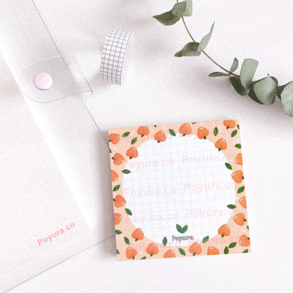 Squared peach memo notepad with white circle and grid inside