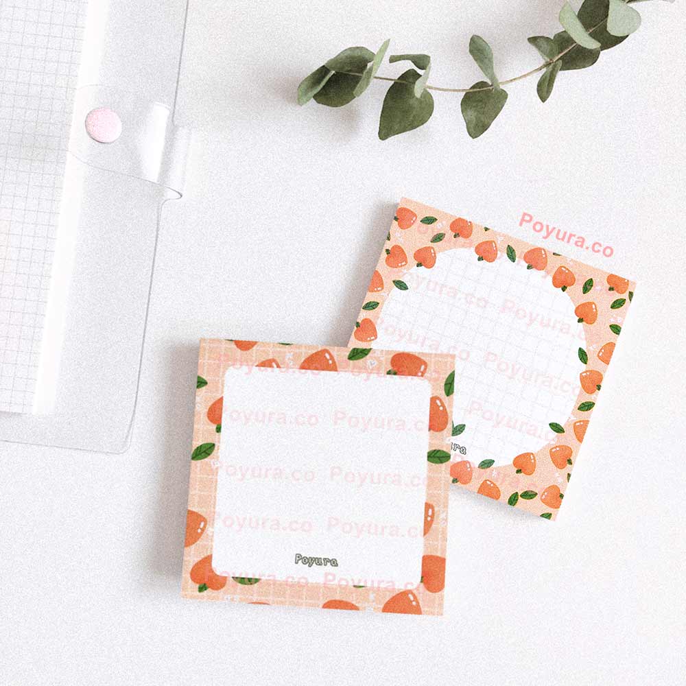 Two matching memo pads with peaches and green leaves