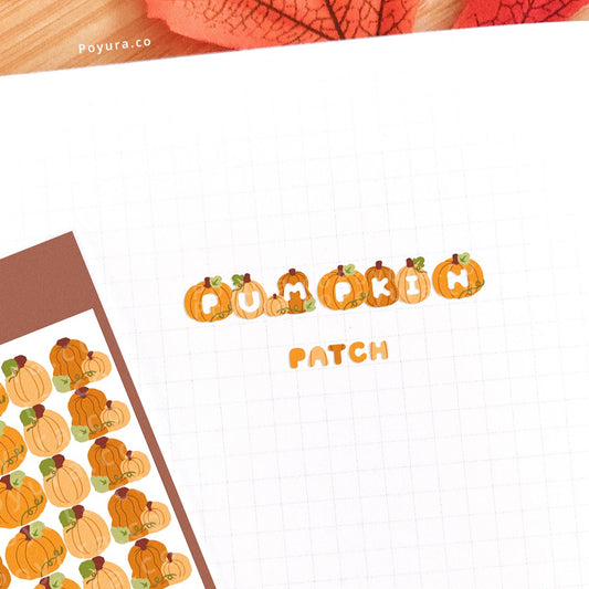 Stickers of cute fall pumpkins with alphabet letter cutouts on a journal