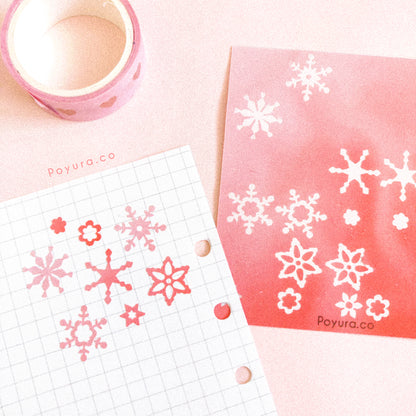 Borderless sticker with snow flake cutouts in different red tints