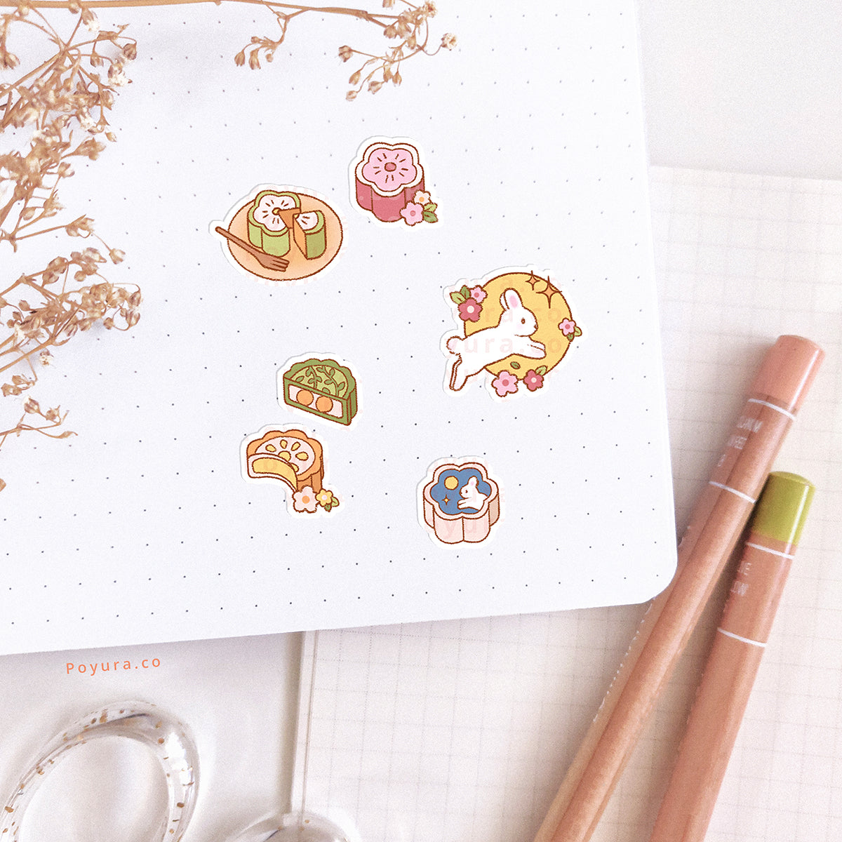 Stickers of colorful mooncakes and bunnies are pasted in a journal spread.