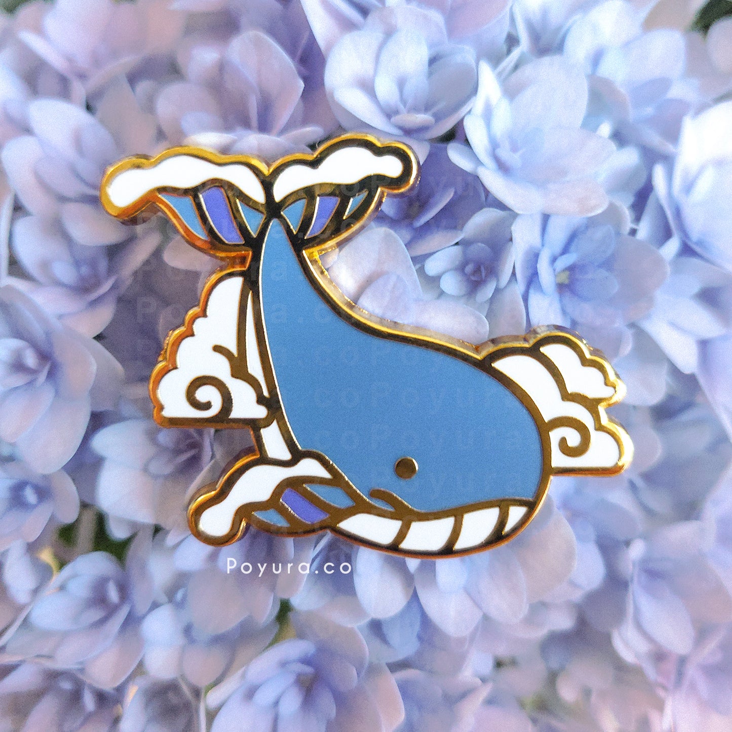 Gold enamel pin of a whale flying in the clouds