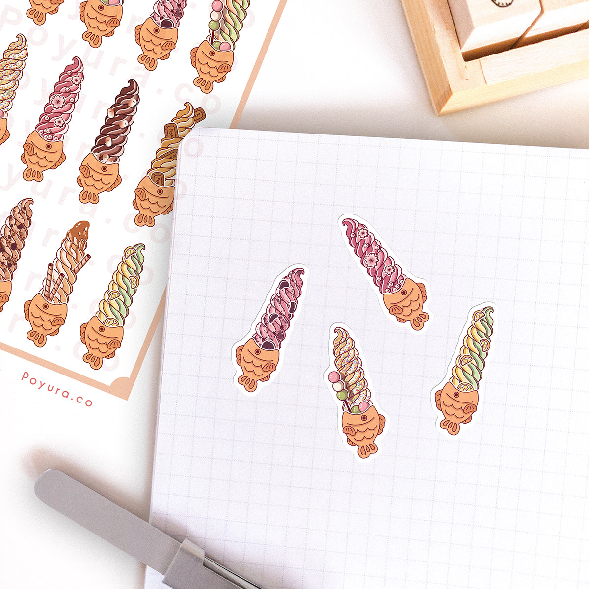 Stickers of cute taiyaki ice cream with flavors like strawberry and chocolate on a journal