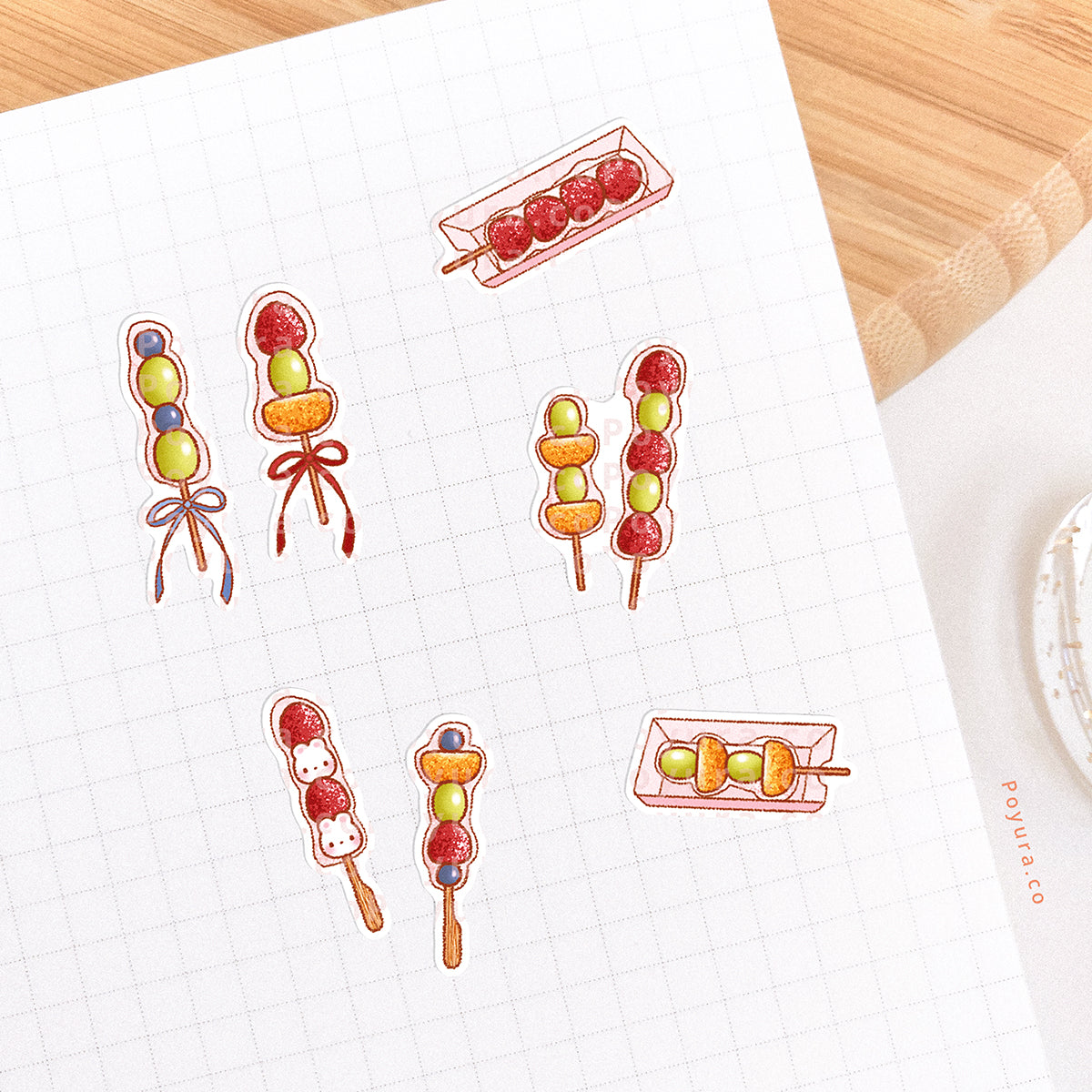 Tanghulu stickers are pasted in a journal spread. Varied candied fruits like strawberry, grape, and mandarin are on sticks.