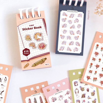 Collection of tiny sticker books with various stickers on a white background