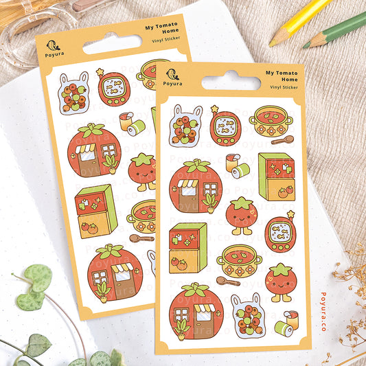 Tomato sticker sheet on an open notebook. The desk is decorated with pencils, a scissor, and some plants.