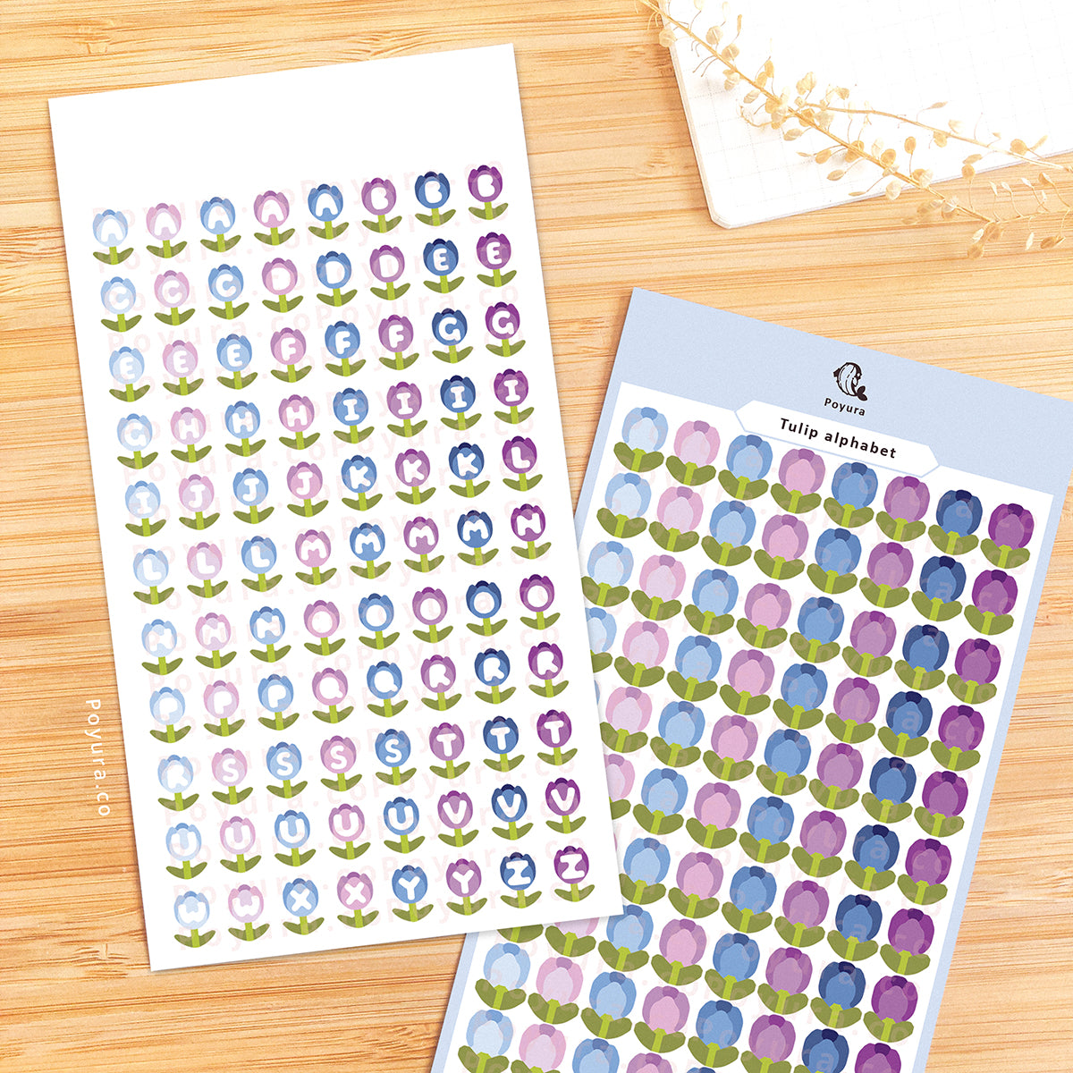 Sticker sheet of blue and purple tulips with alphabet letter cutouts in the center.