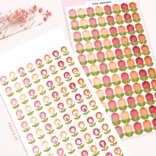 Sticker sheet of pink-red and yellow-orange tulips with alphabet letter cutouts in the center.