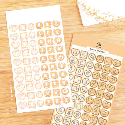 Sticker sheet of natural cookies with alphabet letter cutouts in the center. 